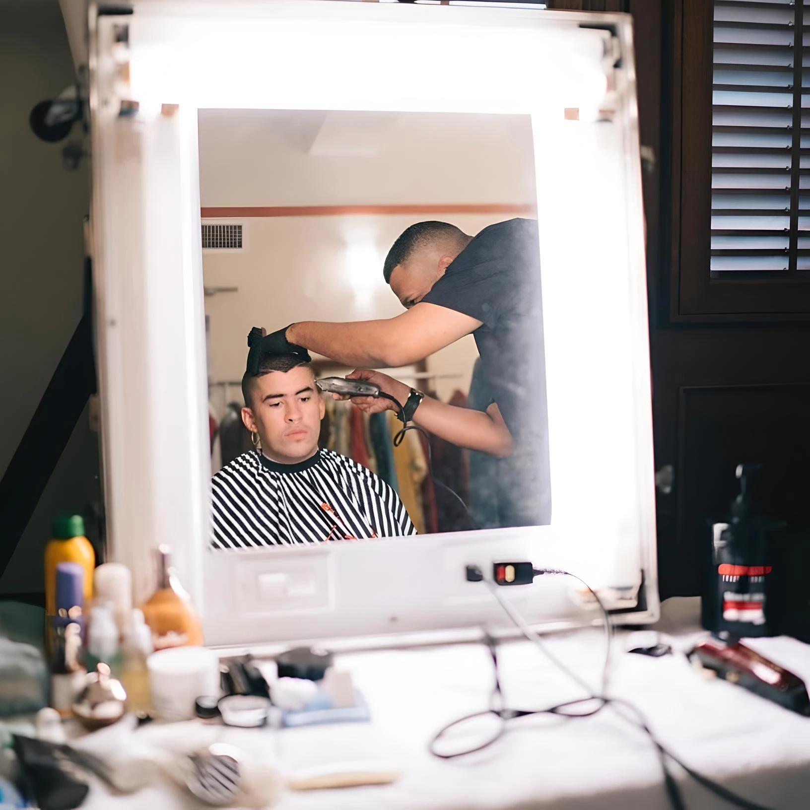 Topher giving Bad Bunny a haircut